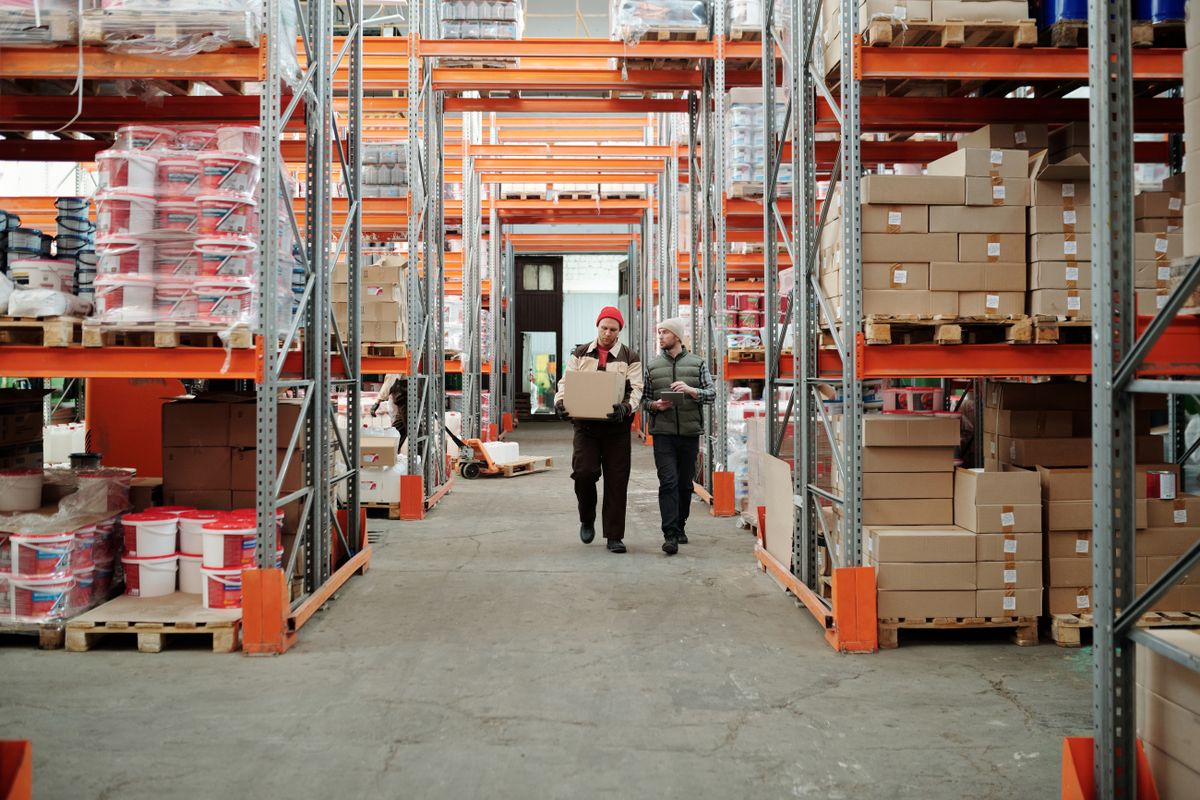 Intérieur d'un entrepôt logistique avec rayonnages et cartons de commandes